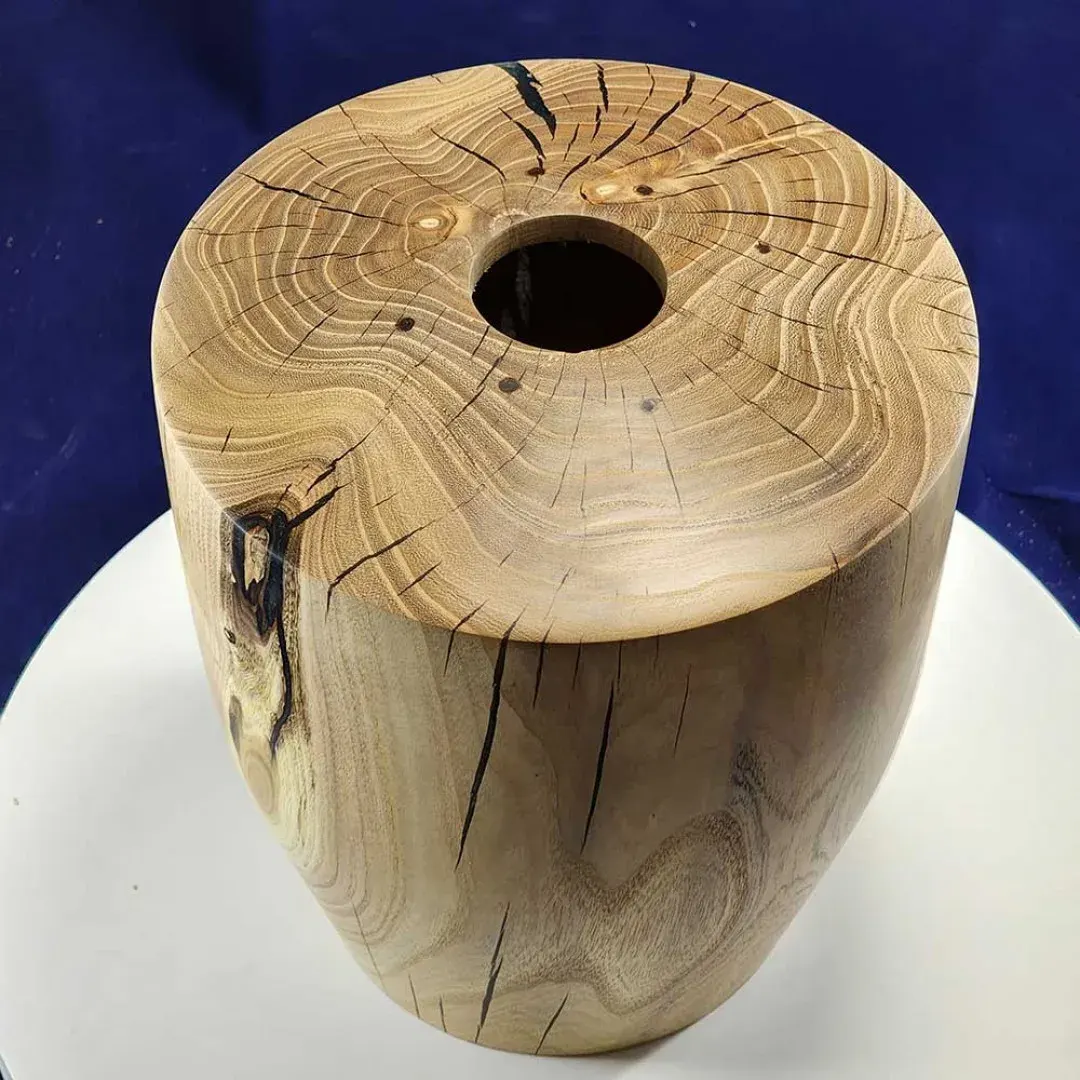 Ash urn, hand-turned, shown top-down on a dark navy velvet backdrop.